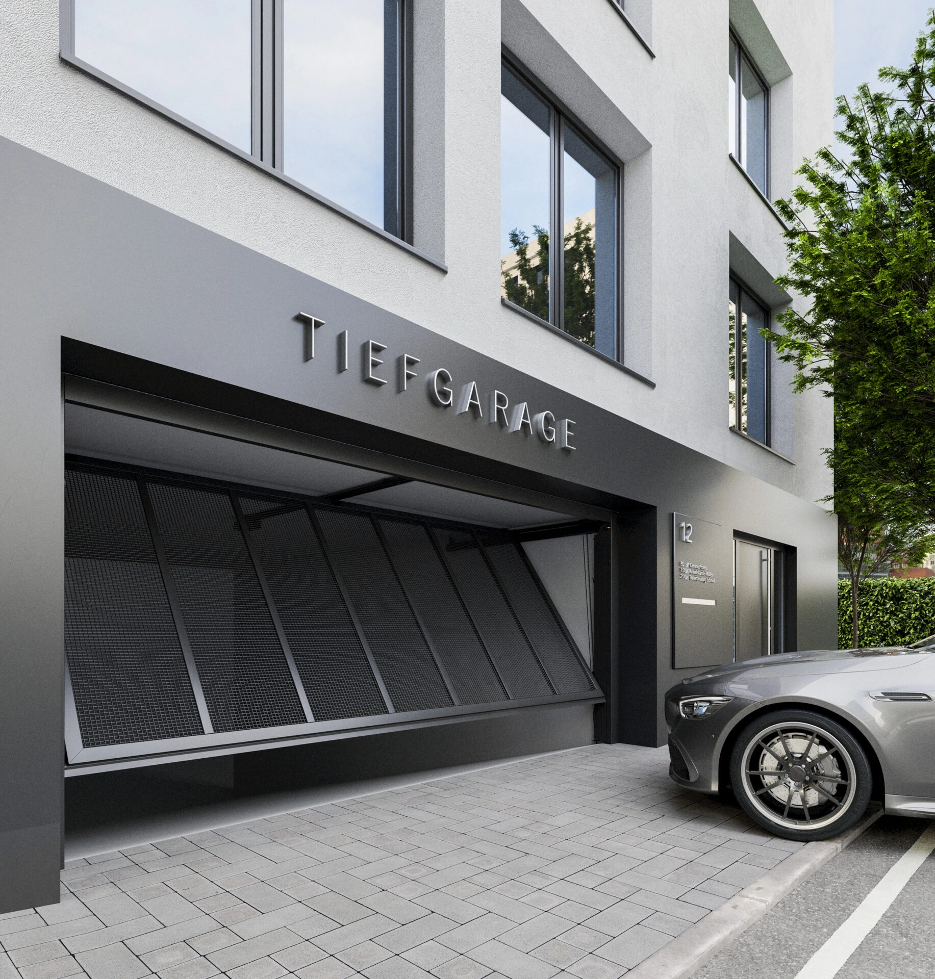 Tiefgaragentor mit Lochblech-Füllung an einer modernen Tiefgarageneinfahrt eines Mehrfamilienhauses, geöffnet